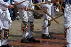 Lower legs of 'cotswold' morris dancers bells, leggings, and sticks